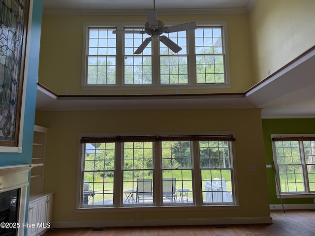 2602 Linden Ln NW, Wilson, NC 27896 - detailed view of a ceiling fan, a high end fireplace, wood finished floors, crown molding, and baseboards