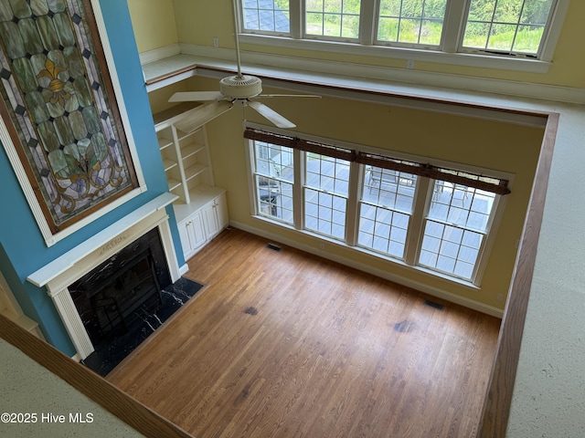 2602 Linden Ln NW, Wilson, NC 27896 - unfurnished living room with ceiling fan, a high end fireplace, light wood finished floors, and baseboards