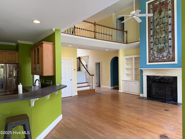 2602 Linden Ln NW, Wilson, NC 27896 - unfurnished living room featuring a fireplace, ornamental molding, stairway, baseboards, and ceiling fan