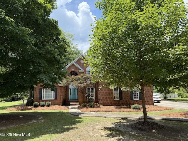 2602 Linden Ln NW, Wilson, NC 27896 - view of property hidden behind natural elements featuring a front lawn and brick siding