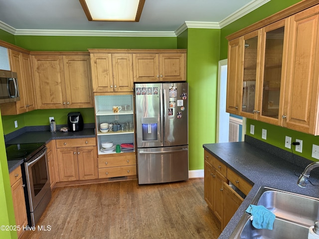 2602 Linden Ln NW, Wilson, NC 27896 - kitchen with appliances with stainless steel finishes, a sink, dark countertops, dark wood finished floors, and ornamental molding