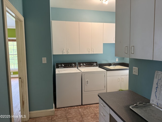 2602 Linden Ln NW, Wilson, NC 27896 - washroom featuring cabinet space, washing machine and clothes dryer, and baseboards