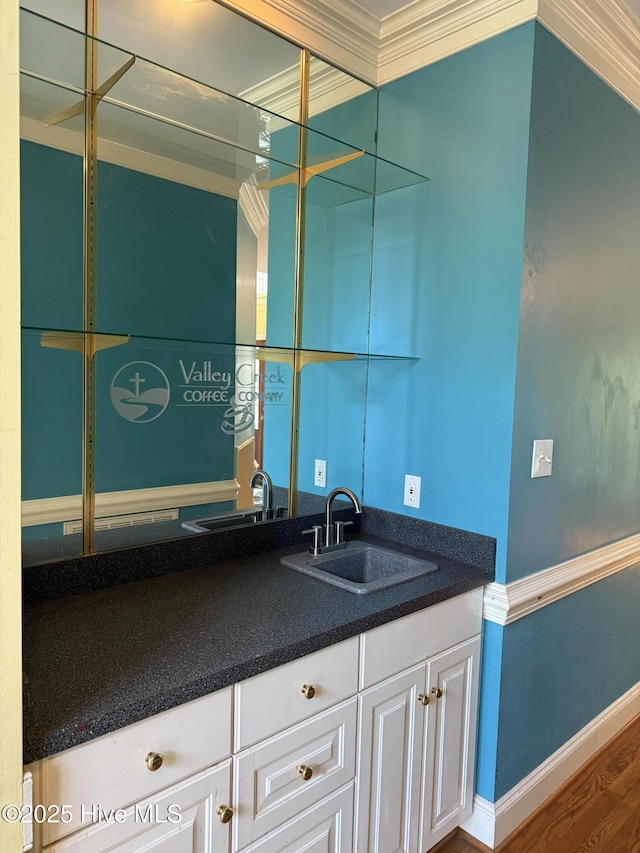 2602 Linden Ln NW, Wilson, NC 27896 - bathroom featuring vanity, wood finished floors, ornamental molding, and baseboards