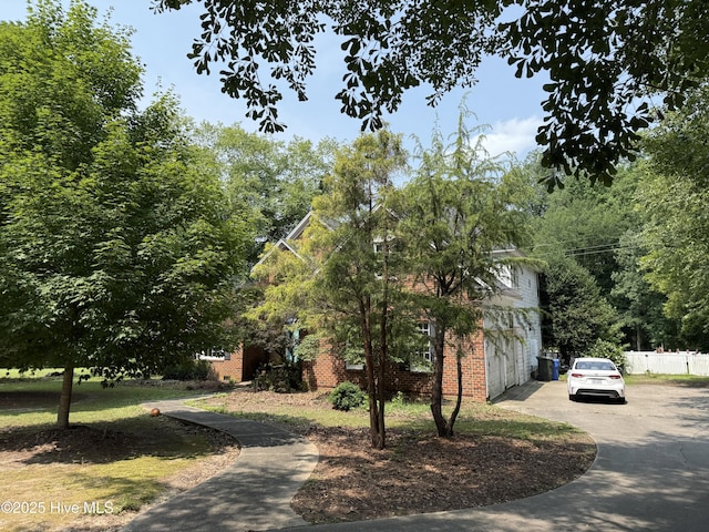 2602 Linden Ln NW, Wilson, NC 27896 - view of home's exterior with concrete driveway, an attached garage, and brick siding