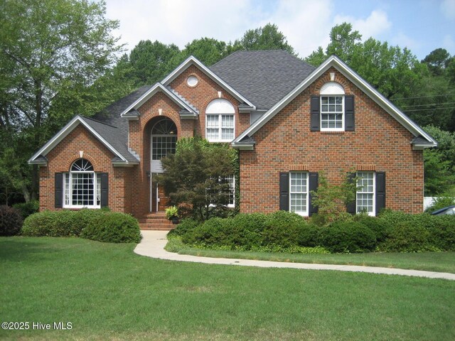 2602 Linden Ln NW, Wilson, NC 27896 - traditional home with brick siding, a front lawn, and a shingled roof