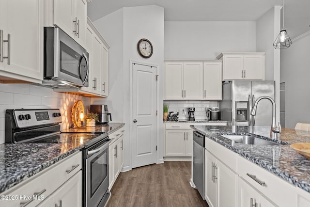 506 Esthwaite Dr SE, Leland, NC 28451 - kitchen featuring appliances with stainless steel finishes, a sink, decorative backsplash, and white cabinetry