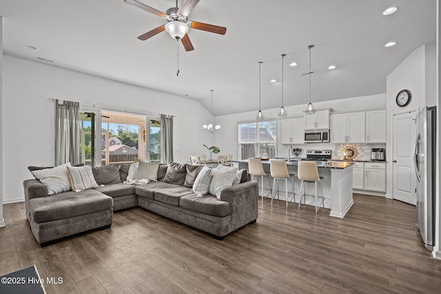 506 Esthwaite Dr SE, Leland, NC 28451 - living room with recessed lighting, a ceiling fan, vaulted ceiling, dark wood-type flooring, and a chandelier