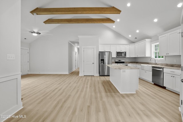 1064 Tulls Creek Rd, Moyock, NC 27958 - kitchen with stainless steel appliances, a kitchen island, high vaulted ceiling, beam ceiling, and white cabinets