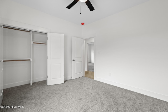 1064 Tulls Creek Rd, Moyock, NC 27958 - unfurnished bedroom featuring carpet floors, a closet, baseboards, and a ceiling fan