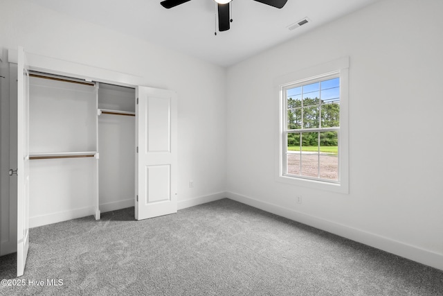 1064 Tulls Creek Rd, Moyock, NC 27958 - unfurnished bedroom featuring carpet flooring, baseboards, a closet, and a ceiling fan