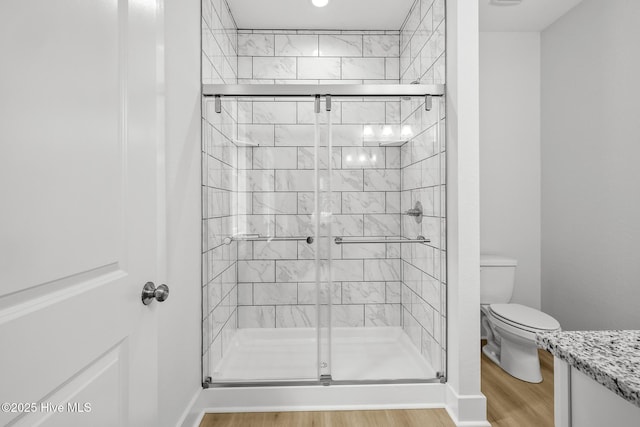 1064 Tulls Creek Rd, Moyock, NC 27958 - bathroom with toilet, wood finished floors, a stall shower, baseboards, and vanity