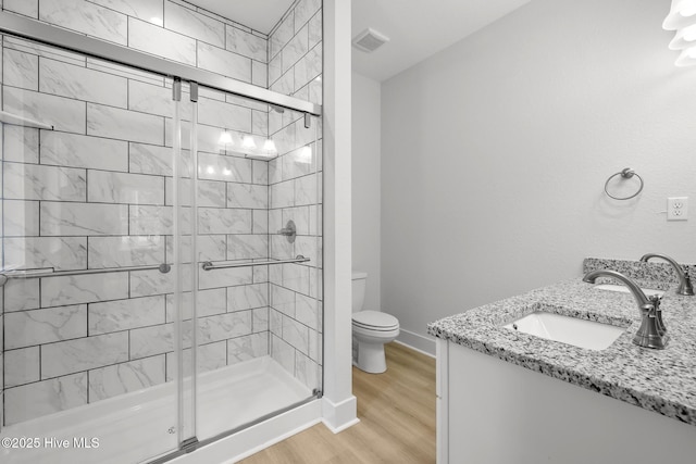1064 Tulls Creek Rd, Moyock, NC 27958 - bathroom with a stall shower, wood finished floors, toilet, and vanity