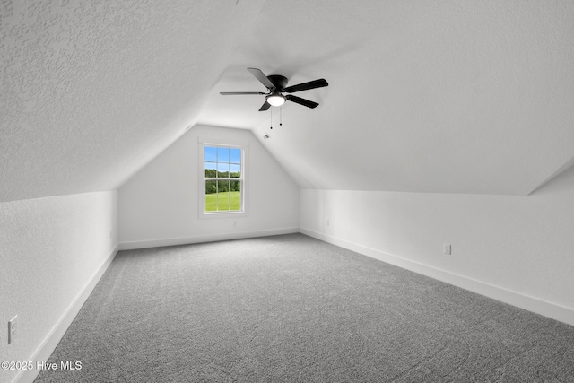 1064 Tulls Creek Rd, Moyock, NC 27958 - bonus room featuring carpet flooring, baseboards, lofted ceiling, a ceiling fan, and a textured ceiling