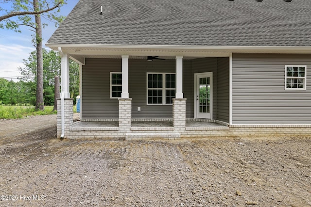 1064 Tulls Creek Rd, Moyock, NC 27958 - back of property featuring a shingled roof, ceiling fan, and a porch