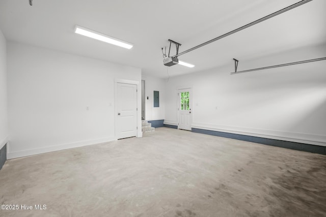 1064 Tulls Creek Rd, Moyock, NC 27958 - garage featuring electric panel, a garage door opener, and baseboards