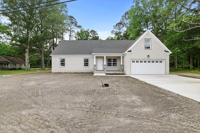 1064 Tulls Creek Rd, Moyock, NC 27958 - view of front of property with driveway, brick siding, and an attached garage