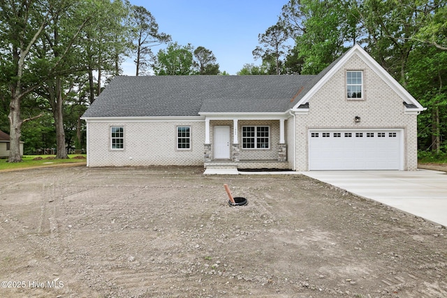 1064 Tulls Creek Rd, Moyock, NC 27958 - view of front of home with brick siding, driveway, a garage, and a shingled roof