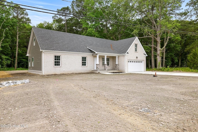 1064 Tulls Creek Rd, Moyock, NC 27958 - view of front of house featuring concrete driveway, brick siding, roof with shingles, and a garage