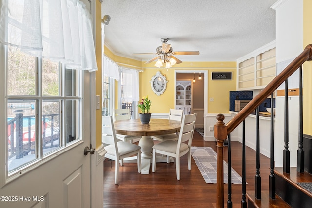 1714 Darian Dr, Elizabeth City, NC 27909 - dining space with stairs, a textured ceiling, ceiling fan, ornamental molding, and dark wood-style floors