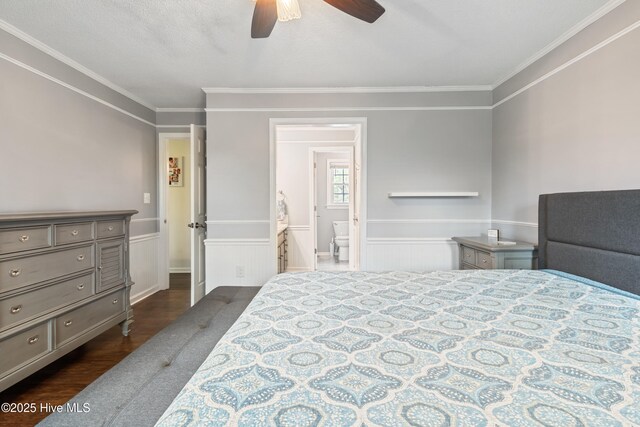 1714 Darian Dr, Elizabeth City, NC 27909 - bedroom featuring a wainscoted wall, connected bathroom, dark wood-type flooring, and ornamental molding