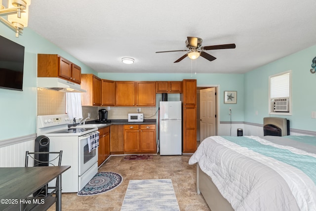 1714 Darian Dr, Elizabeth City, NC 27909 - kitchen featuring ceiling fan, brown cabinetry, under cabinet range hood, and white appliances
