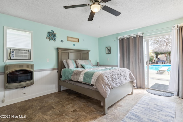 1714 Darian Dr, Elizabeth City, NC 27909 - bedroom with heating unit, a textured ceiling, ceiling fan, a wainscoted wall, and access to outside
