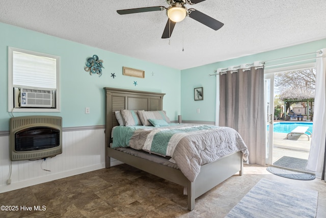 1714 Darian Dr, Elizabeth City, NC 27909 - bedroom with a textured ceiling, cooling unit, wainscoting, heating unit, and access to outside