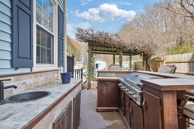 1714 Darian Dr, Elizabeth City, NC 27909 - view of patio featuring fence, area for grilling, a sink, and exterior kitchen