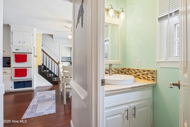 1714 Darian Dr, Elizabeth City, NC 27909 - bathroom featuring backsplash, wood finished floors, a ceiling fan, and vanity
