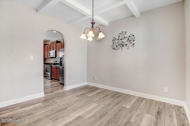  - unfurnished dining area with beamed ceiling, light wood-style floors, baseboards, and coffered ceiling