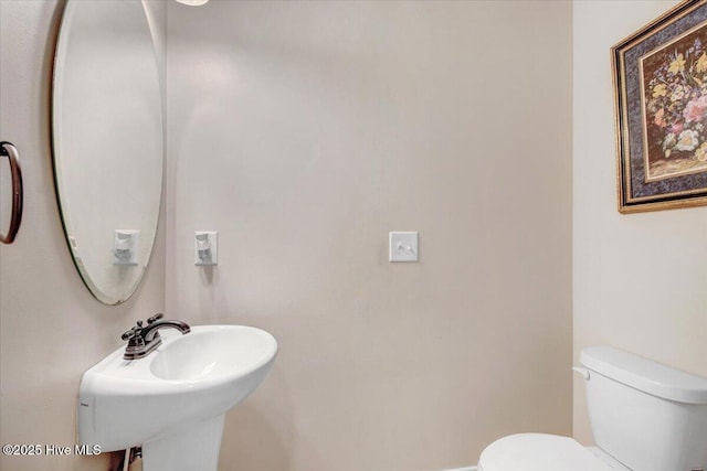  - bathroom featuring toilet and a sink