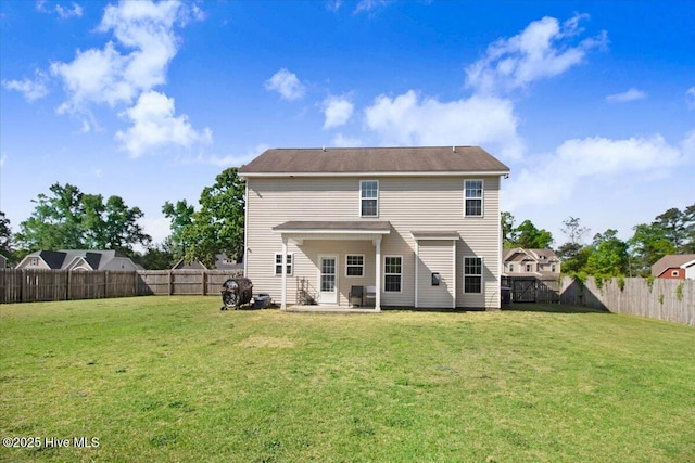 - rear view of property featuring a yard, a patio area, and a fenced backyard