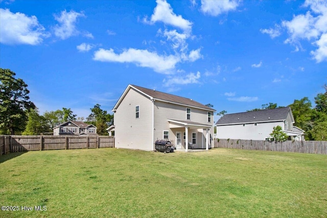  - back of property with a yard, a patio area, and a fenced backyard