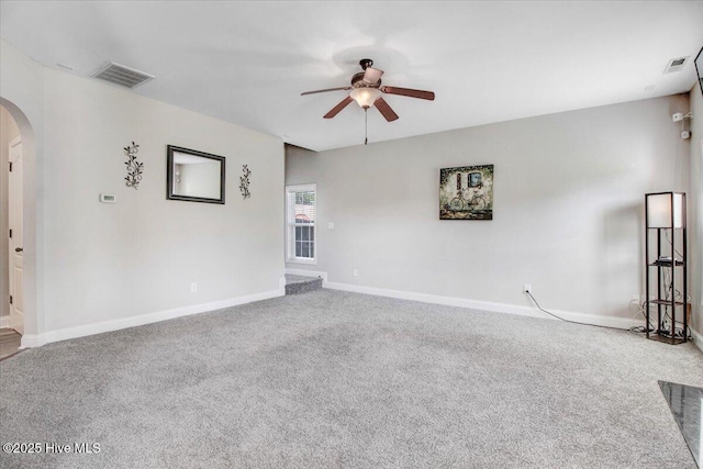  - unfurnished room with arched walkways, a ceiling fan, carpet flooring, and visible vents