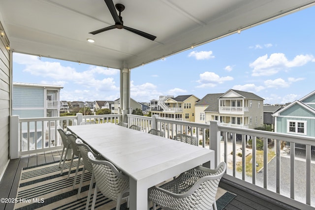 balcony featuring a ceiling fan, a residential view, and outdoor dining space