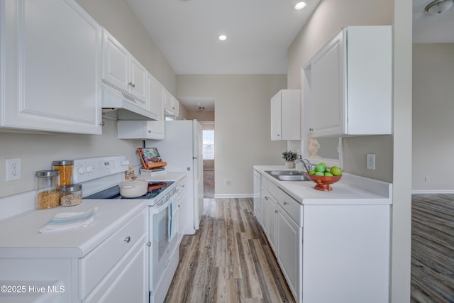 kitchen featuring white range with electric stovetop, under cabinet range hood, a sink, light wood finished floors, and baseboards