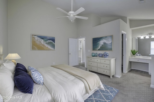 carpeted bedroom with baseboards, a ceiling fan, and high vaulted ceiling
