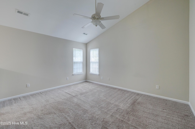 carpeted empty room with baseboards, a ceiling fan, and high vaulted ceiling