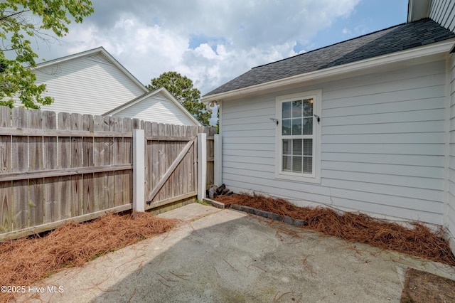 view of patio with fence and a gate