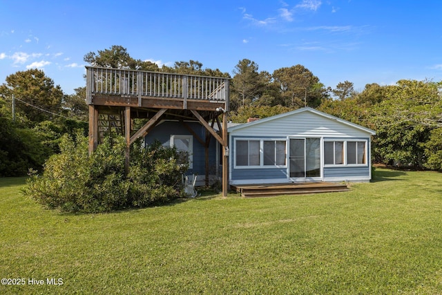 back of house featuring a deck and a yard