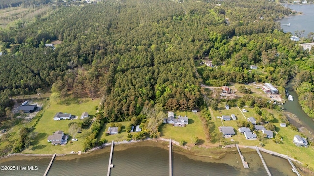 birds eye view of property featuring a wooded view and a water view