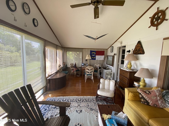 sunroom featuring wood finished floors, a healthy amount of sunlight, and high vaulted ceiling
