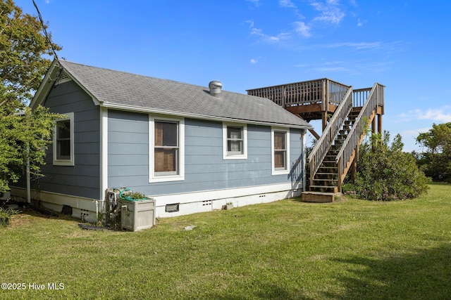 rear view of property with a lawn, stairs, crawl space, and a wooden deck