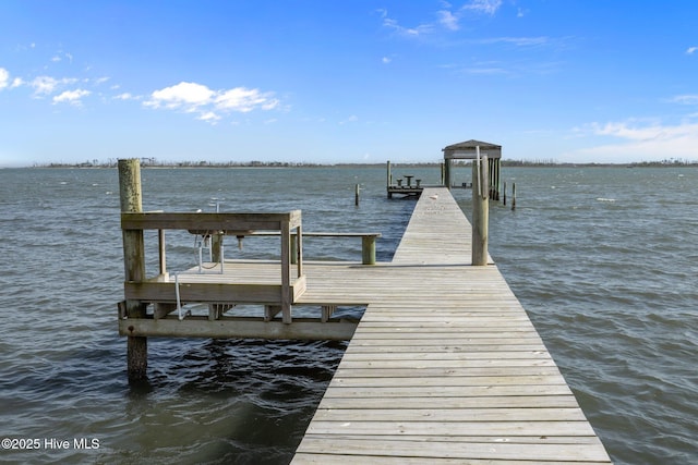 dock area with a water view and boat lift