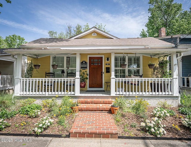 2111 Gibson Ave, Wilmington, NC 28403 - view of front of property featuring roof with shingles, covered porch, and a chimney