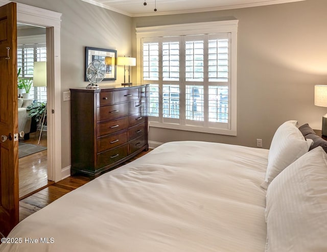2111 Gibson Ave, Wilmington, NC 28403 - bedroom featuring crown molding, baseboards, and dark wood-type flooring