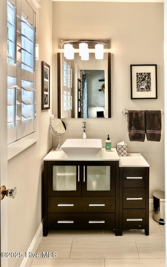 2111 Gibson Ave, Wilmington, NC 28403 - bathroom with baseboards, plenty of natural light, tile patterned floors, and vanity
