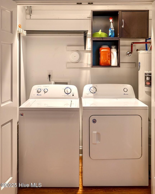 2111 Gibson Ave, Wilmington, NC 28403 - laundry room with electric water heater, separate washer and dryer, cabinet space, and wood finished floors