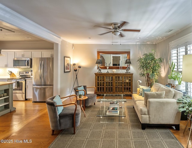 2111 Gibson Ave, Wilmington, NC 28403 - living room with crown molding, a ceiling fan, wood finished floors, and visible vents