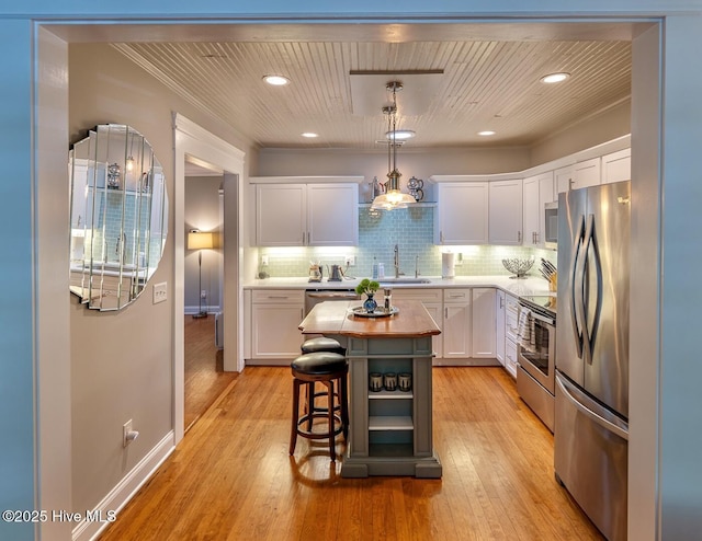 2111 Gibson Ave, Wilmington, NC 28403 - kitchen featuring decorative backsplash, a sink, white cabinets, stainless steel appliances, and butcher block countertops